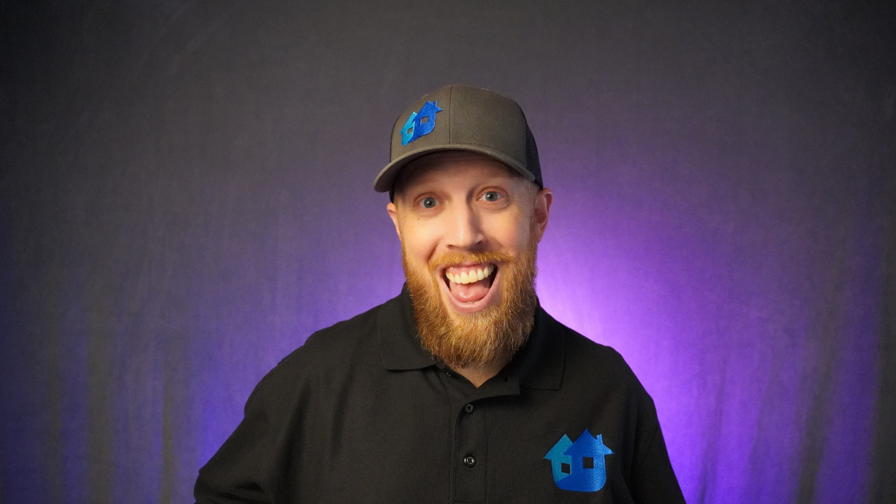 Brandon Gustafson smiling against a purple background